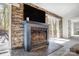Living room with fireplace, stone accent wall, and sliding glass doors to backyard at 4125 Rivendell Ln, Mint Hill, NC 28227