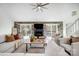Bright living room with fireplace, large windows, and comfortable seating at 4125 Rivendell Ln, Mint Hill, NC 28227