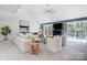Bright living room featuring large sectional, fireplace, and sliding glass doors at 4125 Rivendell Ln, Mint Hill, NC 28227