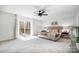 Bright main bedroom featuring a ceiling fan, and a sliding glass door to the outside deck at 4125 Rivendell Ln, Mint Hill, NC 28227