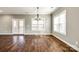 Dining room with wood floors, a chandelier, and natural light from the windows at 4602 Parkwood School Rd, Monroe, NC 28112