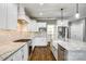 A bright, white kitchen with a large island, granite countertops, and stainless steel appliances at 4602 Parkwood School Rd, Monroe, NC 28112