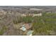 Expansive aerial view showcasing a beautiful home, pool, and surrounding wooded landscape for privacy at 47997 Wagoner Rd, Richfield, NC 28137