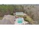 Aerial view featuring a pool, outdoor seating, and lush surroundings, showcasing backyard retreat at 47997 Wagoner Rd, Richfield, NC 28137