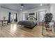 Large primary bedroom features wood-look flooring, a decorative ceiling, and access to a private patio at 47997 Wagoner Rd, Richfield, NC 28137