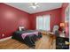 Cozy bedroom with hardwood floors, chair and dresser at 47997 Wagoner Rd, Richfield, NC 28137