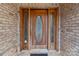 Elegant wooden front door with decorative glass accents, set within a classic brick facade at 47997 Wagoner Rd, Richfield, NC 28137