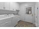 Bright laundry room with white cabinets, sink, and modern washer and dryer at 47997 Wagoner Rd, Richfield, NC 28137