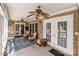 Relaxing outdoor porch with comfortable seating, ceiling fans, and brick accents at 47997 Wagoner Rd, Richfield, NC 28137