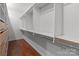Organized walk-in closet featuring built-in shelving and hardwood floors at 47997 Wagoner Rd, Richfield, NC 28137