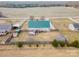 Aerial view of a charming home with a green roof and fenced yard at 515 Brawley Rd, Cleveland, NC 27013