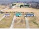 An aerial view showcases the layout of a property with surrounding greenery and neighboring houses at 515 Brawley Rd, Cleveland, NC 27013