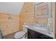 Stylish bathroom featuring wood paneling, granite countertop, and modern fixtures at 515 Brawley Rd, Cleveland, NC 27013