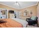 Well-lit bedroom includes a walk-in closet and an adjacent relaxing chair, enhancing comfort and convenience at 515 Brawley Rd, Cleveland, NC 27013