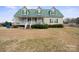 Charming two-story home with green metal roof and inviting front porch at 515 Brawley Rd, Cleveland, NC 27013