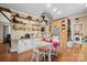 Bright kitchen boasts wood floors, open shelves, stainless steel appliances, and a charming farmhouse dining table at 515 Brawley Rd, Cleveland, NC 27013