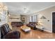Cozy living room featuring leather furniture, a fireplace, and hardwood floors at 515 Brawley Rd, Cleveland, NC 27013