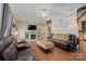 Cozy living room featuring leather furniture, a fireplace, and hardwood floors at 515 Brawley Rd, Cleveland, NC 27013