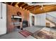 Cozy basement featuring a brick fireplace with hearth, exposed ceiling and finished flooring at 63 Wagner Rd, Taylorsville, NC 28681