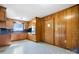 Classic kitchen with wood paneling, blue countertops, tile floors, and bright window at 63 Wagner Rd, Taylorsville, NC 28681