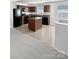 Modern kitchen with dark wood cabinets and a center island at 6324 Cutwater Cir, Charlotte, NC 28269