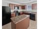 Kitchen with dark brown cabinets, a black refrigerator, and an island at 6324 Cutwater Cir, Charlotte, NC 28269