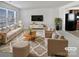 Spacious living room featuring beige sofas, a coffee table, and a large TV at 6324 Cutwater Cir, Charlotte, NC 28269