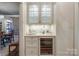 Convenient bar area with glass door cabinets, wine cooler, and ample storage for entertaining at 641 Museum Dr, Charlotte, NC 28207