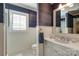 Elegant bathroom with white wainscoting, shuttered window, and stylish mirror at 641 Museum Dr, Charlotte, NC 28207