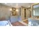 A luxurious bathroom featuring custom cabinets, patterned wallpaper and a soaking tub at 641 Museum Dr, Charlotte, NC 28207