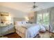 Inviting bedroom with hardwood floors, large windows, and a ceiling fan at 641 Museum Dr, Charlotte, NC 28207