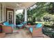 Inviting covered patio with comfortable seating and a view of the lush backyard at 641 Museum Dr, Charlotte, NC 28207