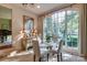 Bright dining area with a modern table set and oversized window overlooking lush greenery at 641 Museum Dr, Charlotte, NC 28207