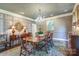 Formal dining room with elegant chandelier, stylish rug and decorative wall paneling at 641 Museum Dr, Charlotte, NC 28207