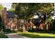 Stately brick home with manicured lawn, mature trees and circular driveway at 641 Museum Dr, Charlotte, NC 28207
