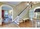 Grand foyer with beautiful staircase, hardwood floors and decorative wallpaper at 641 Museum Dr, Charlotte, NC 28207