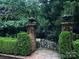 Charming garden gate surrounded by lush greenery and brick pillars at 641 Museum Dr, Charlotte, NC 28207