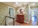 Upper hallway with hardwood floors and decorative wallpaper, leading to various rooms at 641 Museum Dr, Charlotte, NC 28207