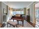 This formal living room has crown molding, a piano, and plenty of natural light from bay windows at 641 Museum Dr, Charlotte, NC 28207