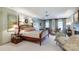 Comfortable main bedroom with a sitting area and natural light from windows with custom drapes at 641 Museum Dr, Charlotte, NC 28207