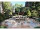 Charming outdoor dining area with a large table surrounded by lush landscaping at 641 Museum Dr, Charlotte, NC 28207