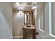 Stylish powder room featuring a unique vanity, decorative mirror, and elegant wallpaper at 641 Museum Dr, Charlotte, NC 28207