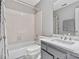 Clean bathroom, featuring a bathtub, toilet and vanity with marble countertop at 6717 Paces Ferry Ln, Charlotte, NC 28226