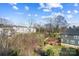 Lush backyard view showcases mature trees and an inviting home exterior at 7020 Loso Commons Way, Charlotte, NC 28217