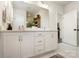 Bright bathroom features a double vanity with white cabinets and marble countertops at 7020 Loso Commons Way, Charlotte, NC 28217
