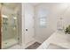 Bright bathroom with tiled walk-in shower, window and modern vanity at 7020 Loso Commons Way, Charlotte, NC 28217