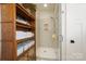 Modern bathroom features a glass-enclosed shower and built-in storage shelves at 7020 Loso Commons Way, Charlotte, NC 28217