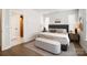 Comfortable main bedroom boasts natural light from large windows, neutral walls, and stylish decor at 7020 Loso Commons Way, Charlotte, NC 28217