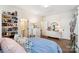 Bedroom featuring a blue bed, dressers, storage for shoes and hardwood floors at 7020 Loso Commons Way, Charlotte, NC 28217