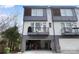 Modern townhome featuring two-story design, gray siding, and a two-car garage at 7020 Loso Commons Way, Charlotte, NC 28217